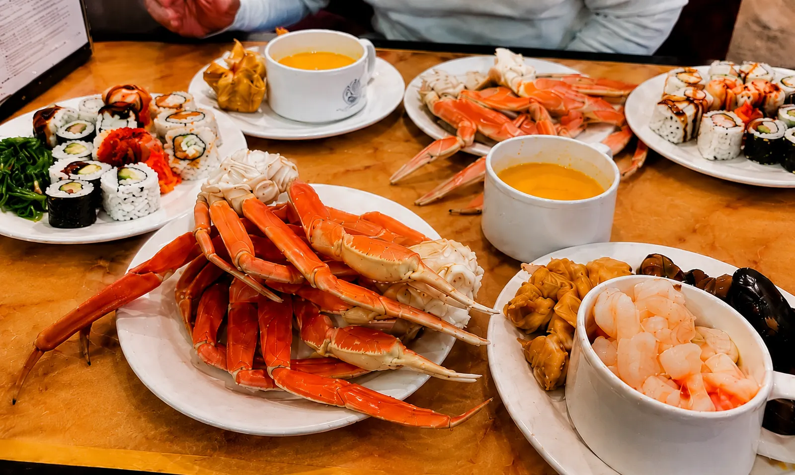 Snow crab legs, sushi, shrimp, and soup served at Best Buffet & Grill